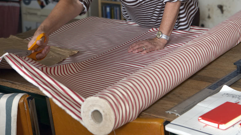 woman cutting large fabric