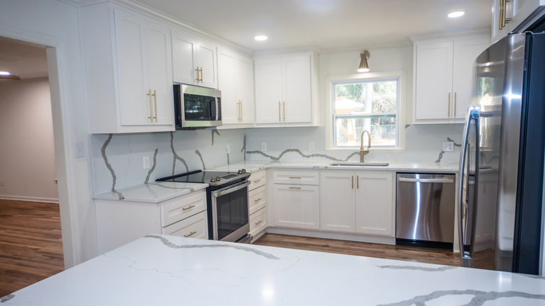 Newly remodeled white kitchen with quartz countertops