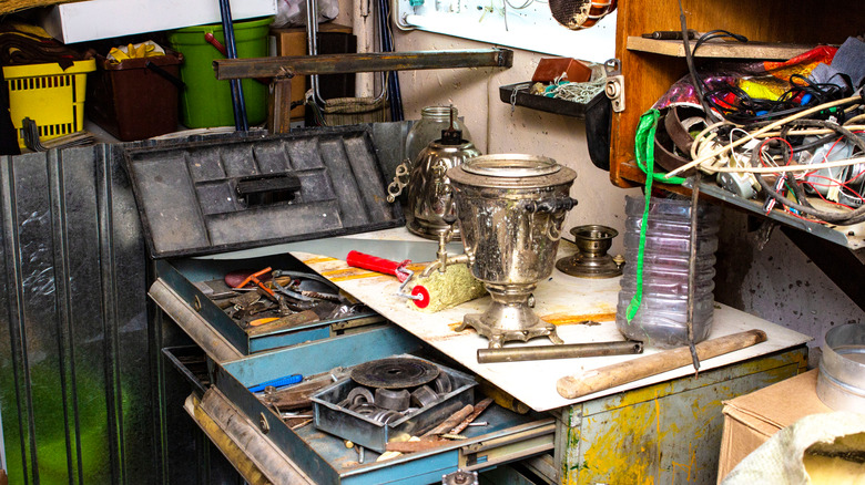 disorganized, messy garage with workbench