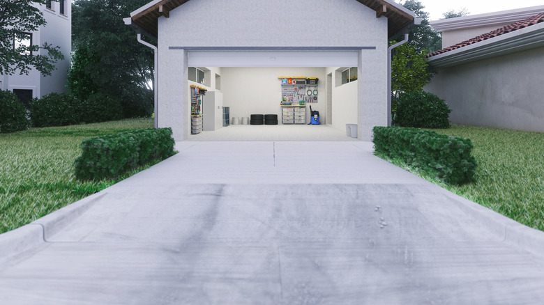 A large smooth driveway leading to an open garage