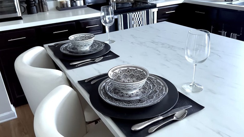 Black and white dinnerware from Dollar Tree presented on a marble island in an upscale kitchen.