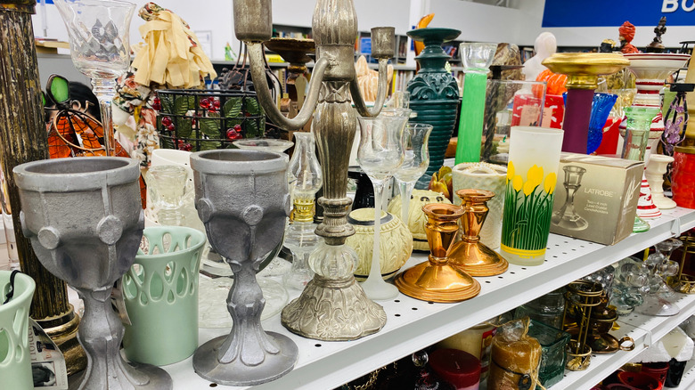 Assorted candle holders in a thrift store