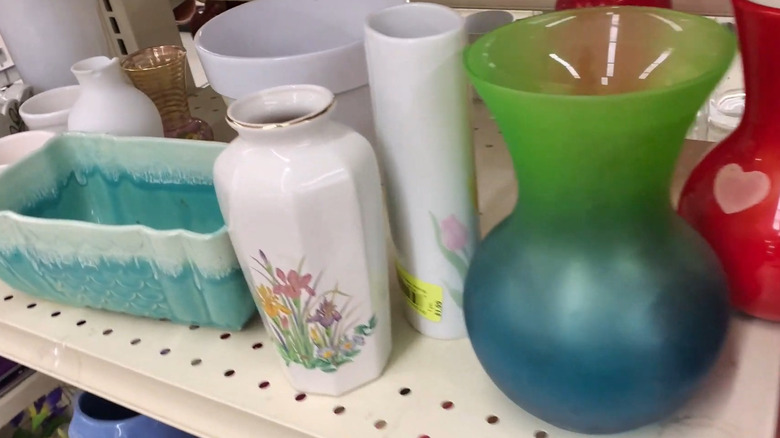 Various planters on a shelf in a thrift store