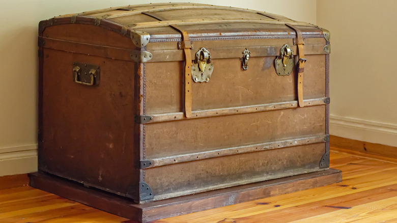 Antique wooden trunk sitting in the corner