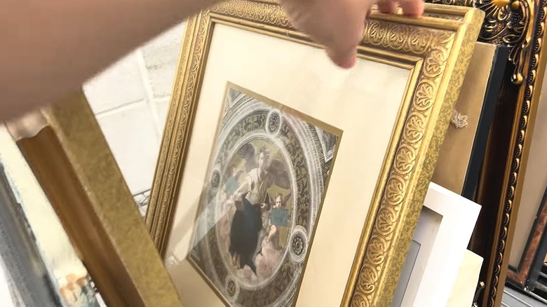 Person looking through frames at a thrift store