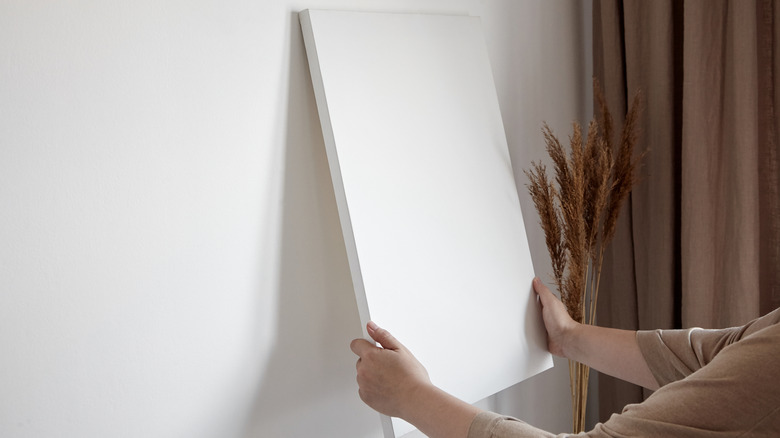 person hanging art