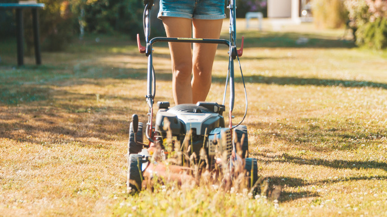 Closeup of woman pushing a lawnmower