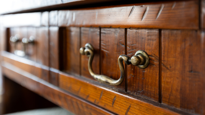 closeup of antique desk drawer with brass pulls