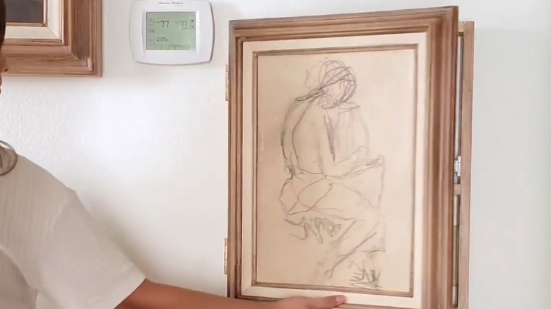 painting hung on hinged frame