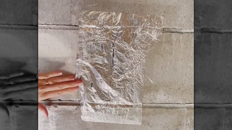 Conducting the Foil Strip Test for water on a brick foundation wall