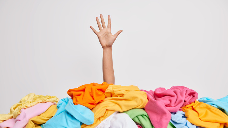Person under a pile of clothing