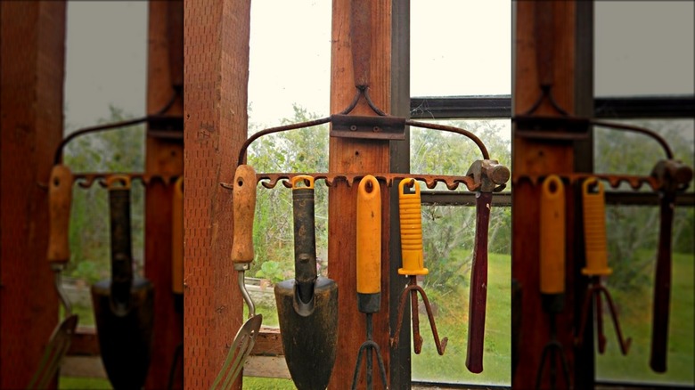 rake used to hold garden tools