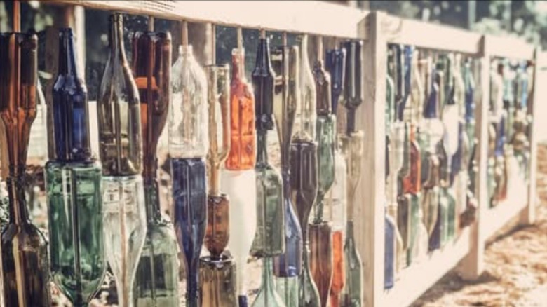 Glass bottle fence in yard