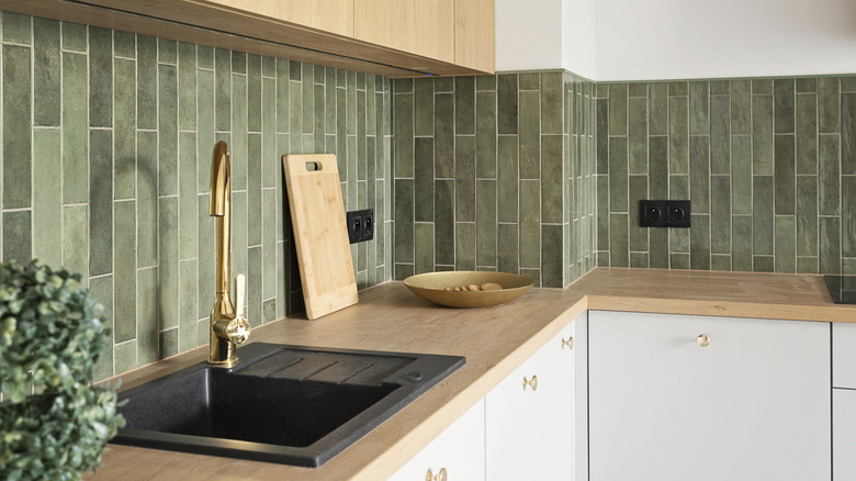 Kitchen with a green tile backsplash