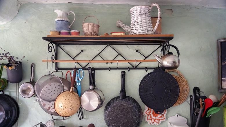 Hanging pots and pans in kitchen
