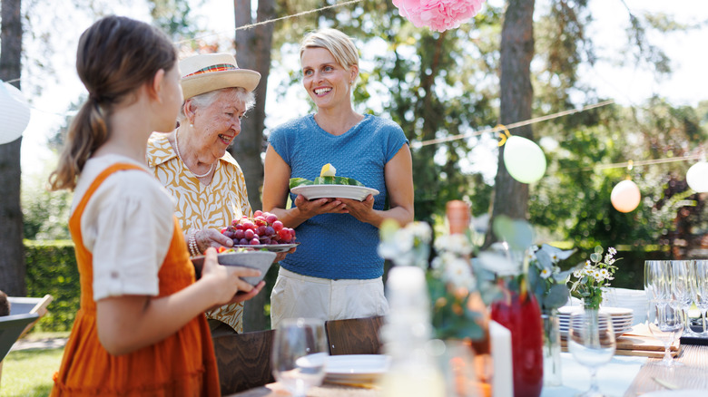 Family outside around picnic table