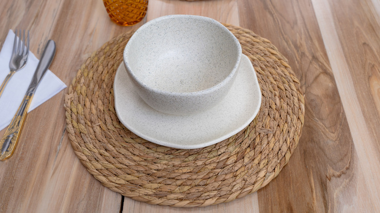 A rattan placemat under dishes