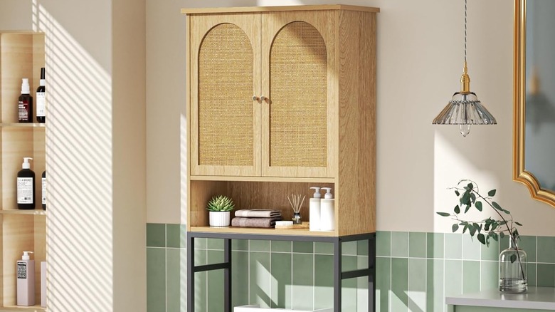 A rattan over-the-toilet cabinet in a bathroom