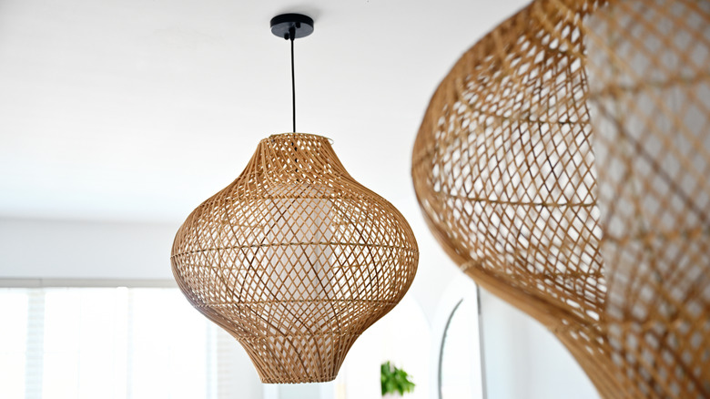 A rattan light fixture hanging from the ceiling