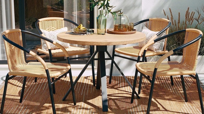 Rattan chairs around a wooden table