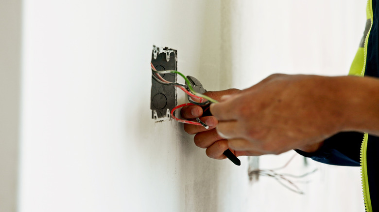 An electrician working with wiring in a home