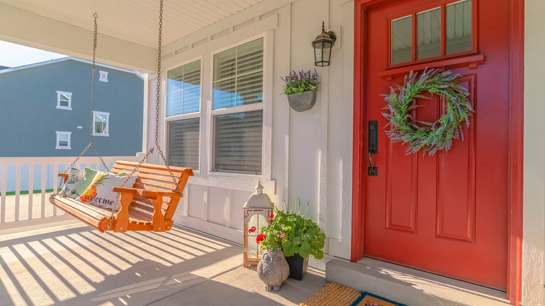 Orange porch swing red door