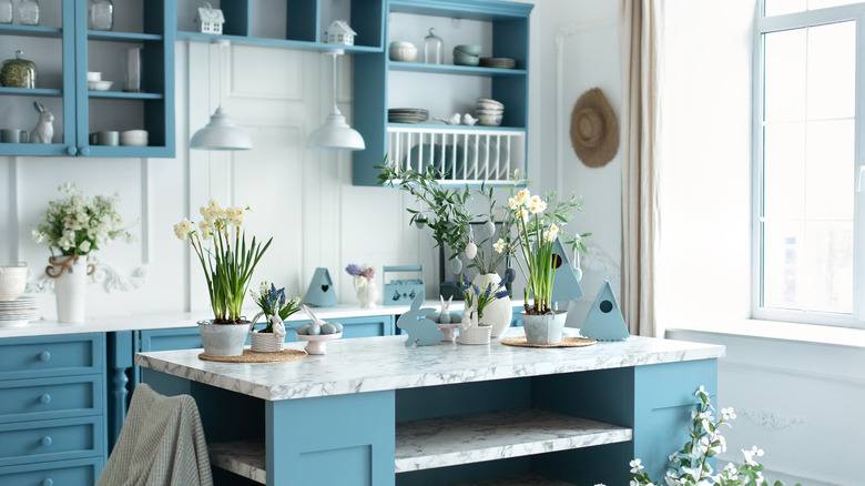 An airy kitchen with a blue and white color scheme.
