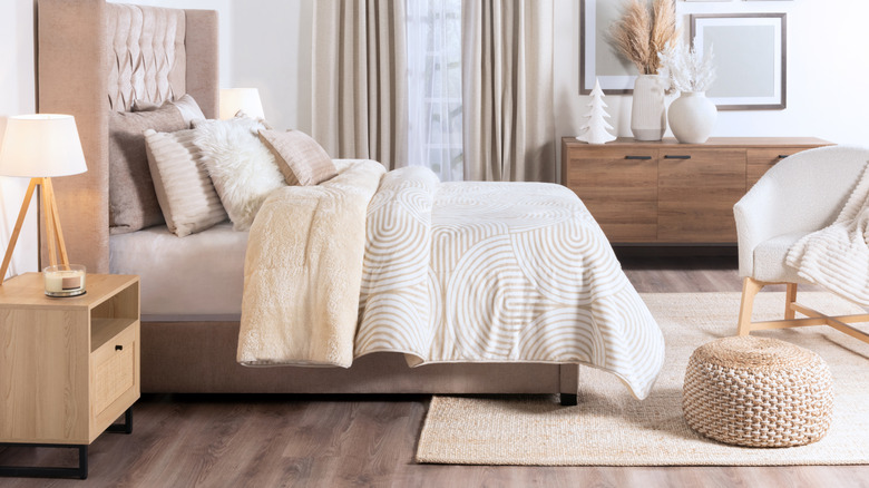 A warm bedroom done in neutral tones of white and beige