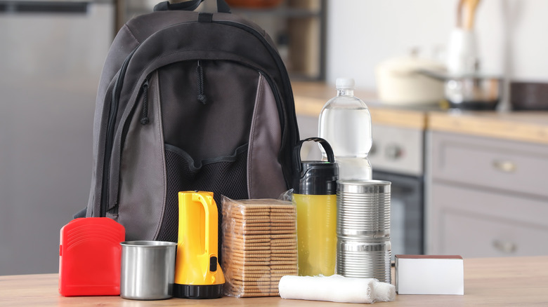 Emergency backpack with supplies sitting on a table in a kitchen