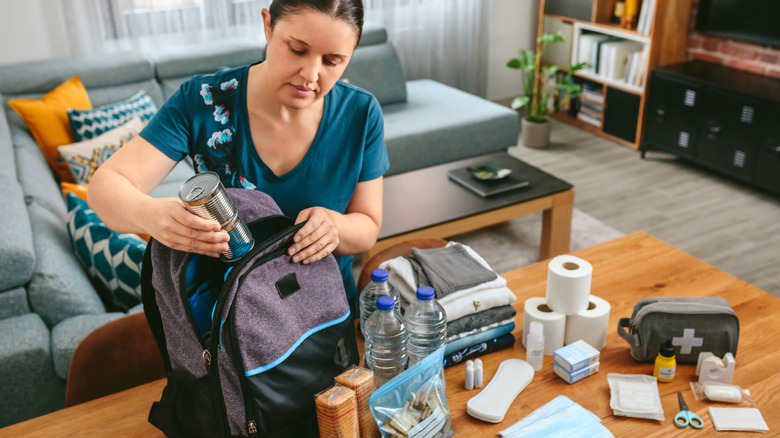 Woman packing a bag for emergencies