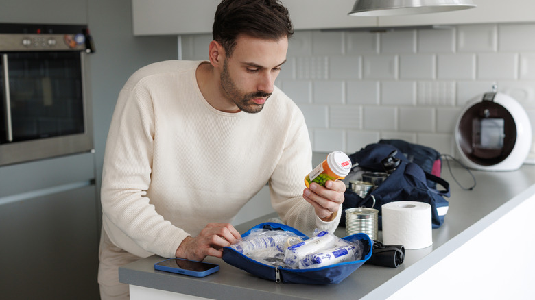 Man looking through an emergency pack