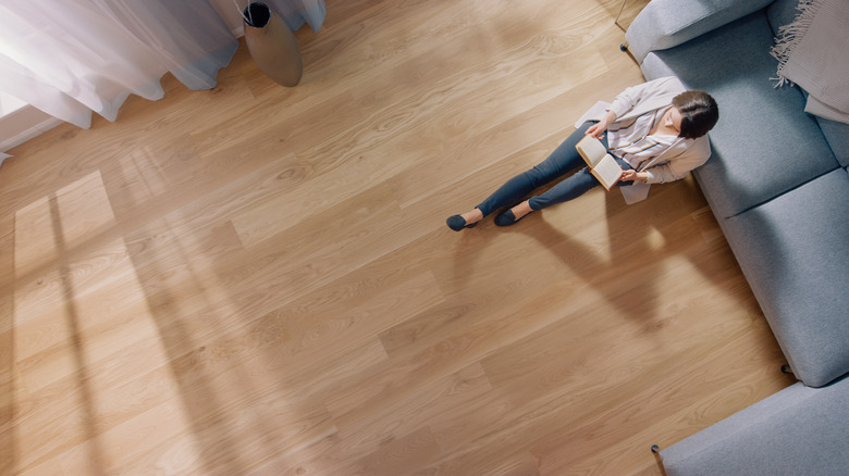 woman reading on bamboo flooring