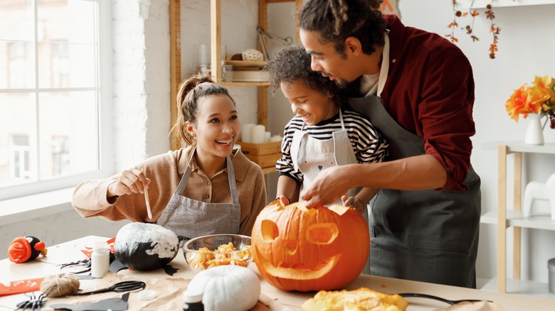 Family carving a pumpkin