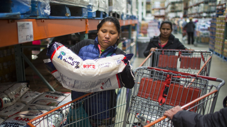 woman lifting bag of rice