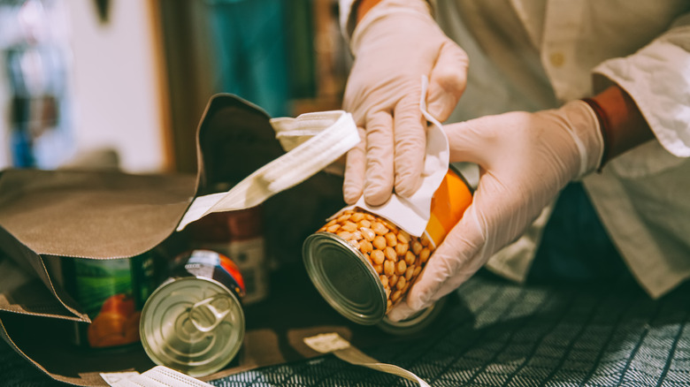 wiping down can of beans