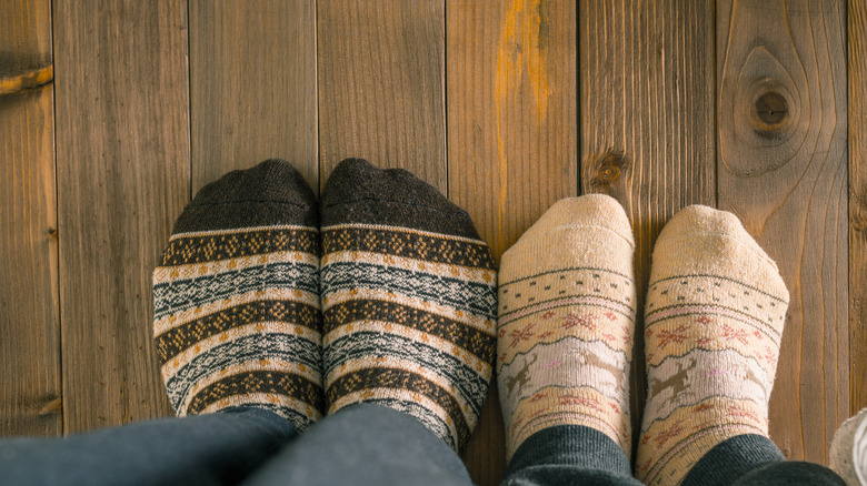 Two pairs of feet wood floor