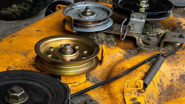 Cleaning debris from a riding mower deck