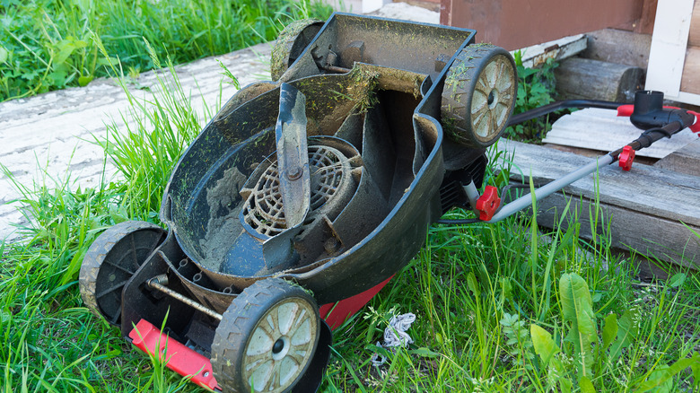 Upside down push mower in grass