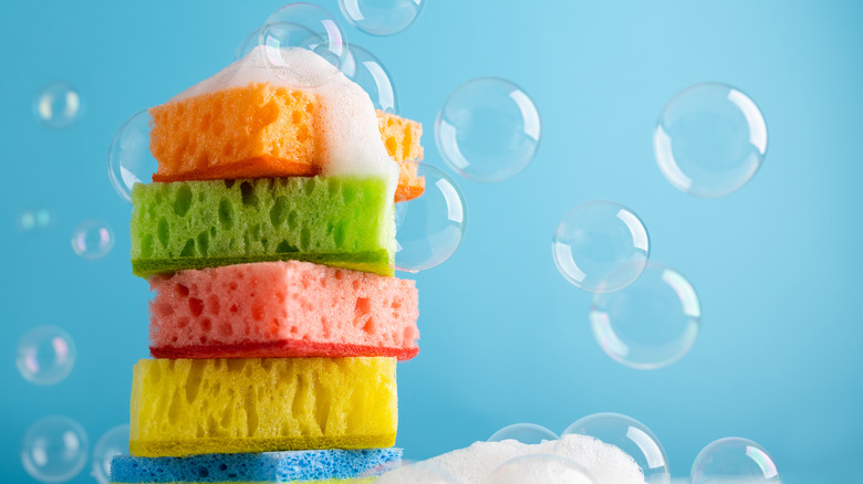 stack of colorful sponges with suds