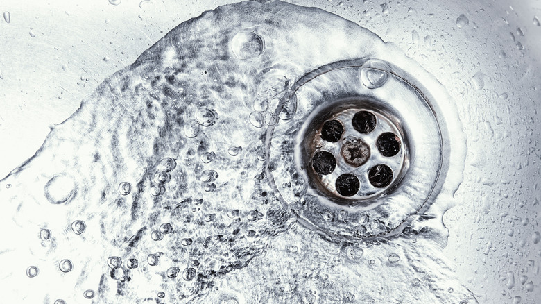 water draining down stainless steel sink