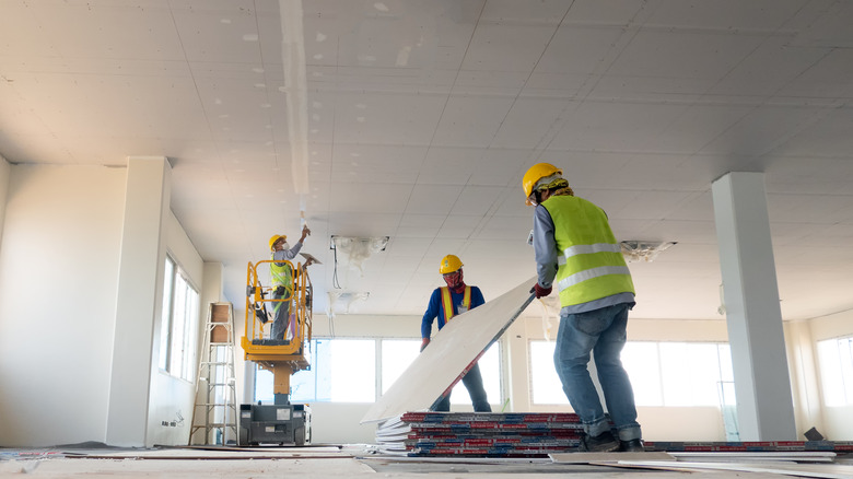 contractor putting up drywall