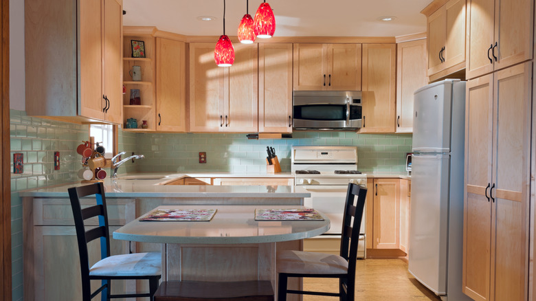 G-shaped kitchen design with peninsula and seating area