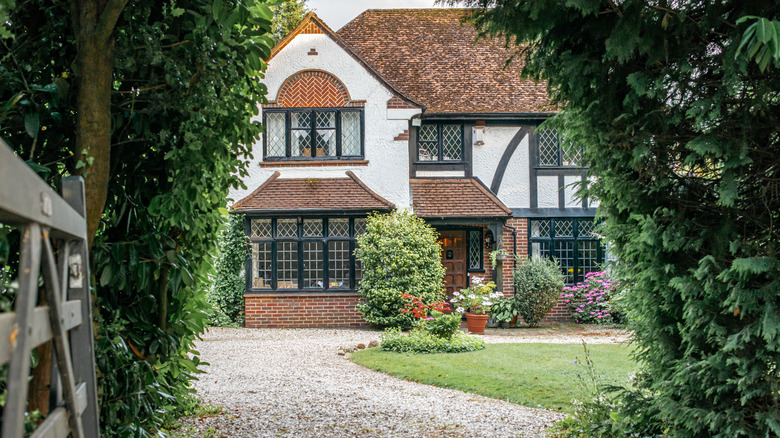 brick home with gravel driveway