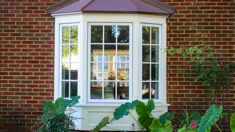 Outside view of bay window with bricks and plants