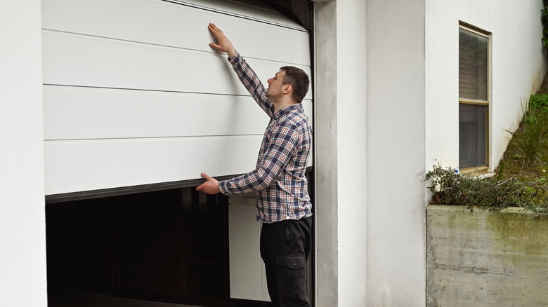 A man inspecting his garage door