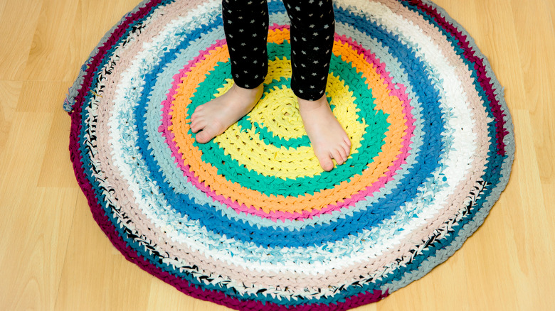 child on a rag rug