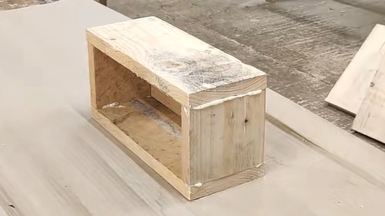 Glue oozes from the joints in a newly made wooden box.