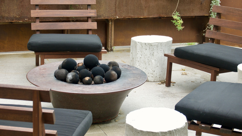 Metal fire pit with seating on patio