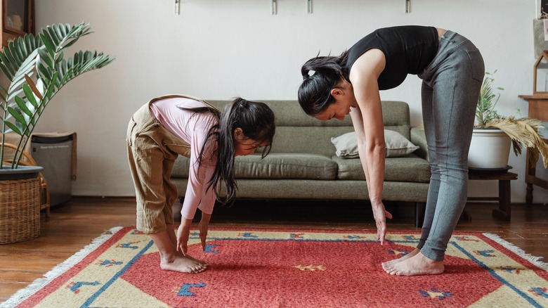 Family stretching on area rug