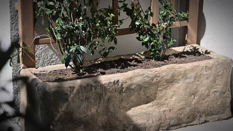 A completed DIY faux limestone planter with an antique look